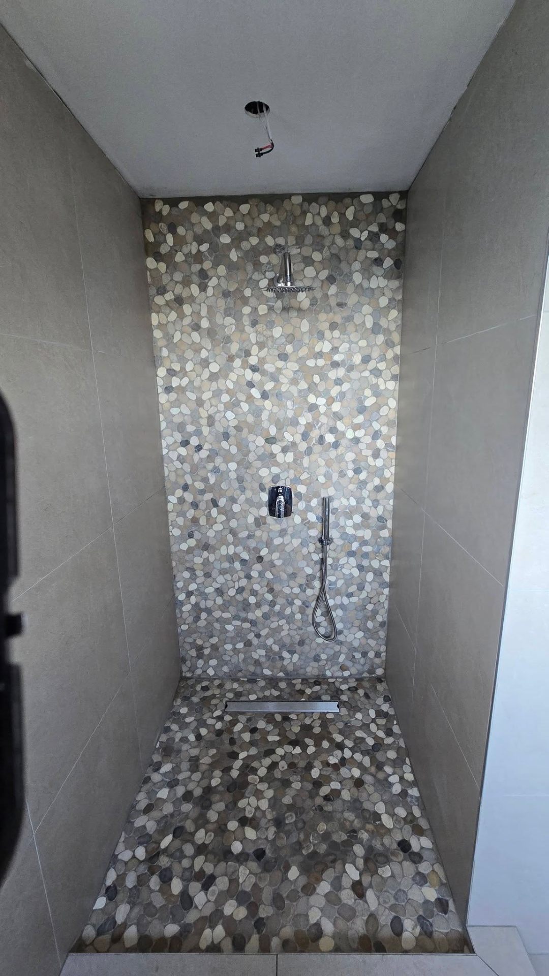 Stone mosaic walk-in shower